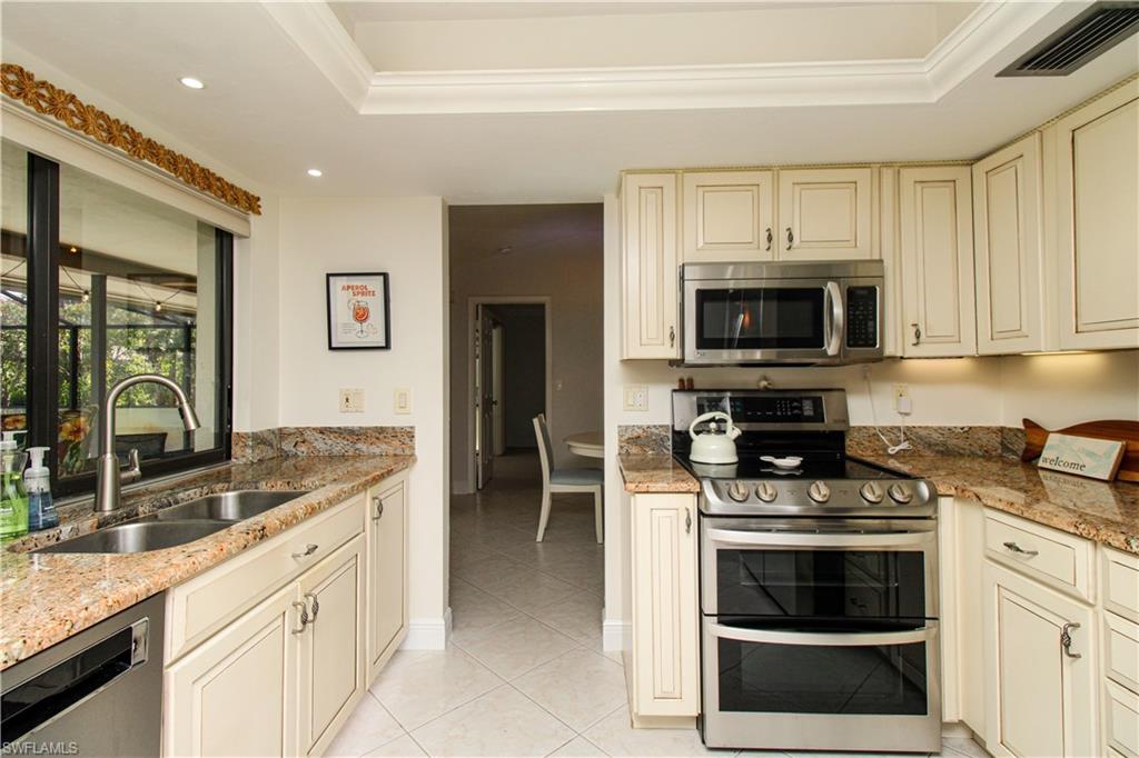 213 Bay Meadows Drive Naples, FL 34113 - Photo 20 of 50 a kitchen with granite countertop a sink and steel appliances