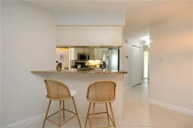 a view of dining table chairs and window