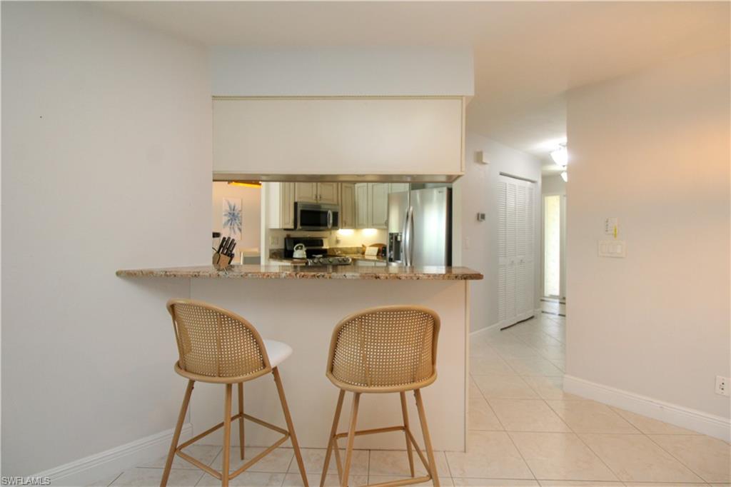 213 Bay Meadows Drive Naples, FL 34113 - Photo 23 of 50 a view of dining table chairs and window