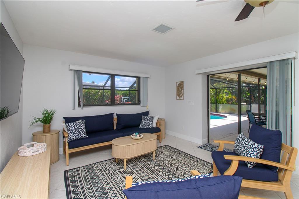 213 Bay Meadows Drive Naples, FL 34113 - Photo 24 of 50 a living room with furniture and a window