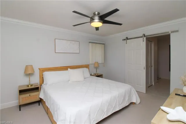 a bedroom with a bed and a ceiling fan