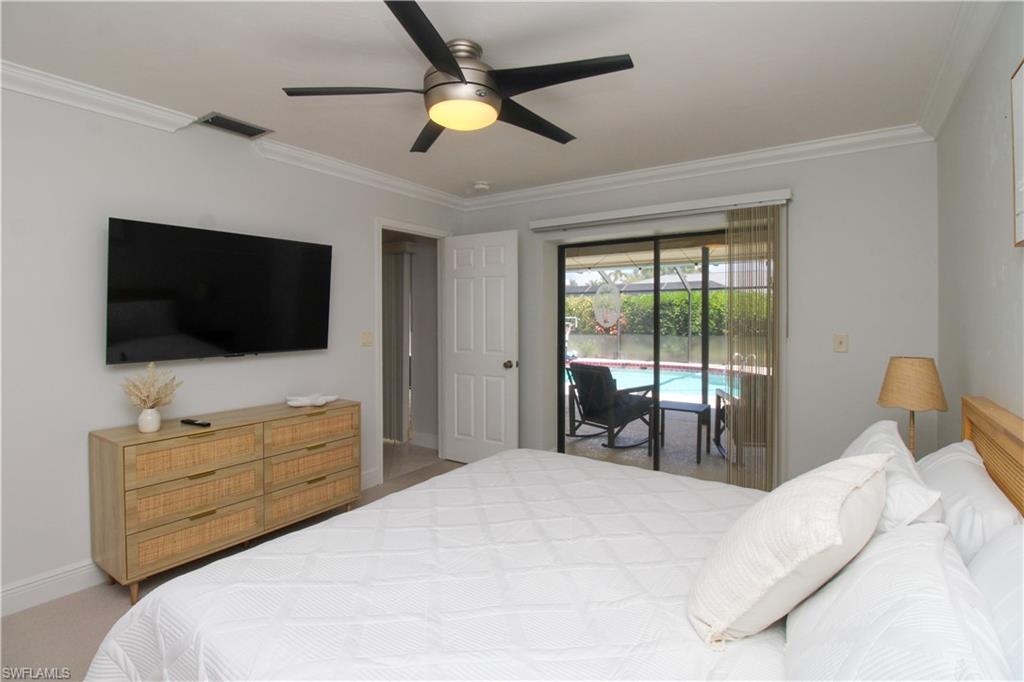 213 Bay Meadows Drive Naples, FL 34113 - Photo 30 of 50 a bedroom with a bed and a flat screen tv