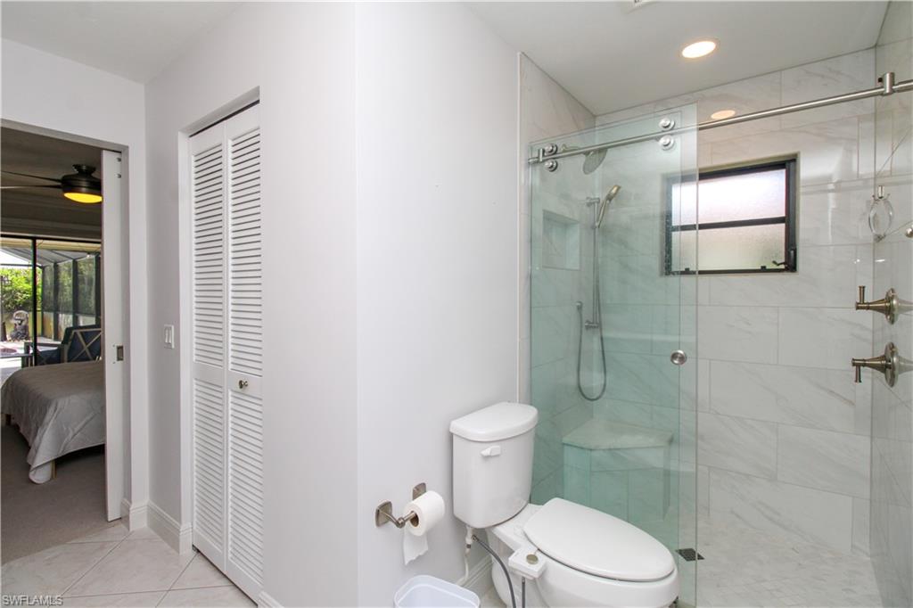 213 Bay Meadows Drive Naples, FL 34113 - Photo 33 of 50 a bathroom with a toilet and shower