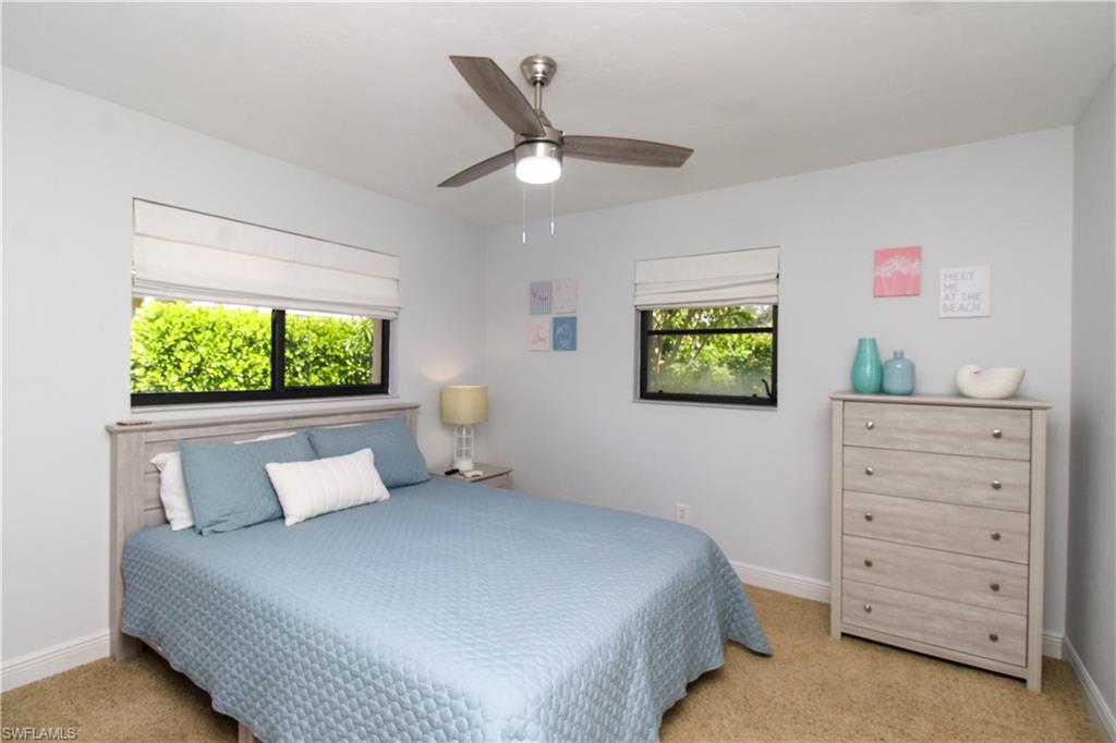 213 Bay Meadows Drive Naples, FL 34113 - Photo 34 of 50 a bedroom with a bed and a window