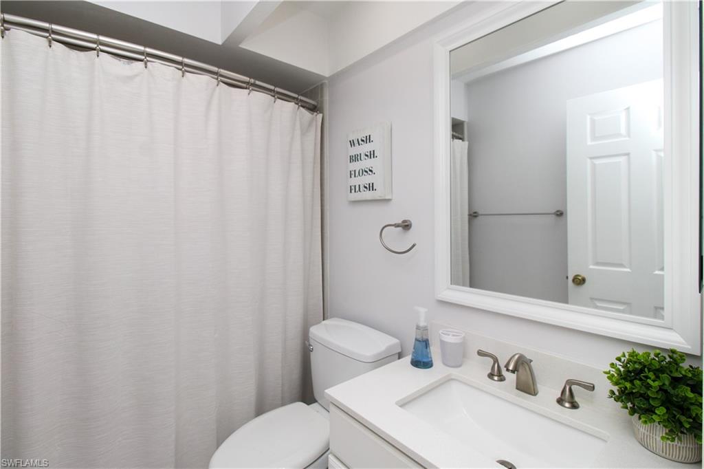 213 Bay Meadows Drive Naples, FL 34113 - Photo 36 of 50 a bathroom with a sink and a mirror