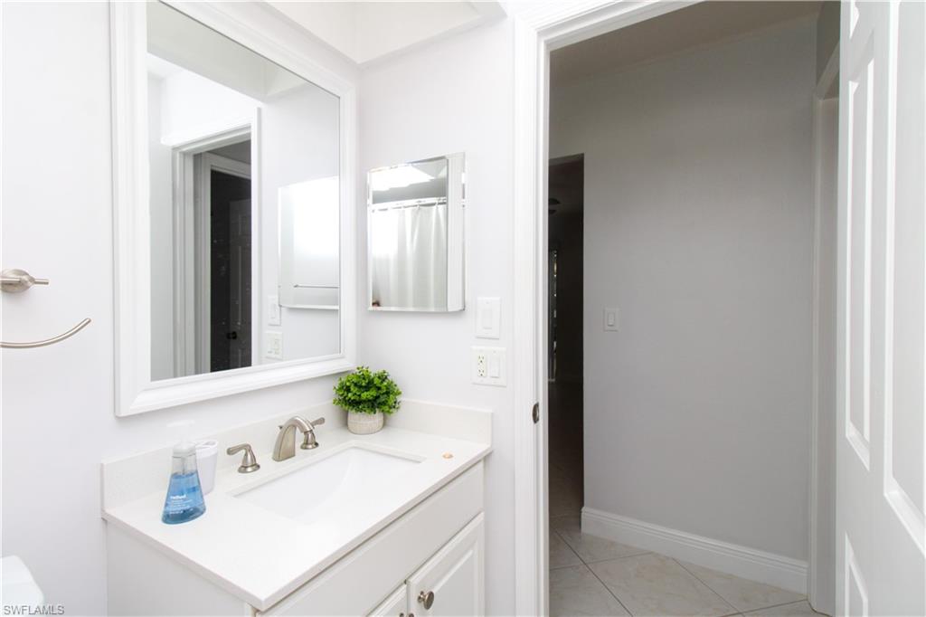 213 Bay Meadows Drive Naples, FL 34113 - Photo 37 of 50 a bathroom with a sink and a mirror