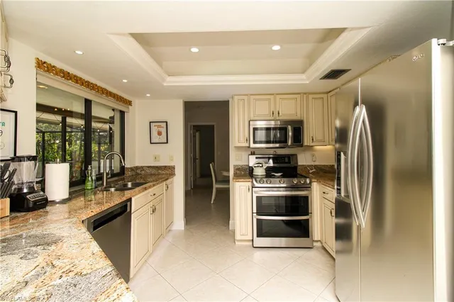 a kitchen with stainless steel appliances granite countertop a stove and a refrigerator