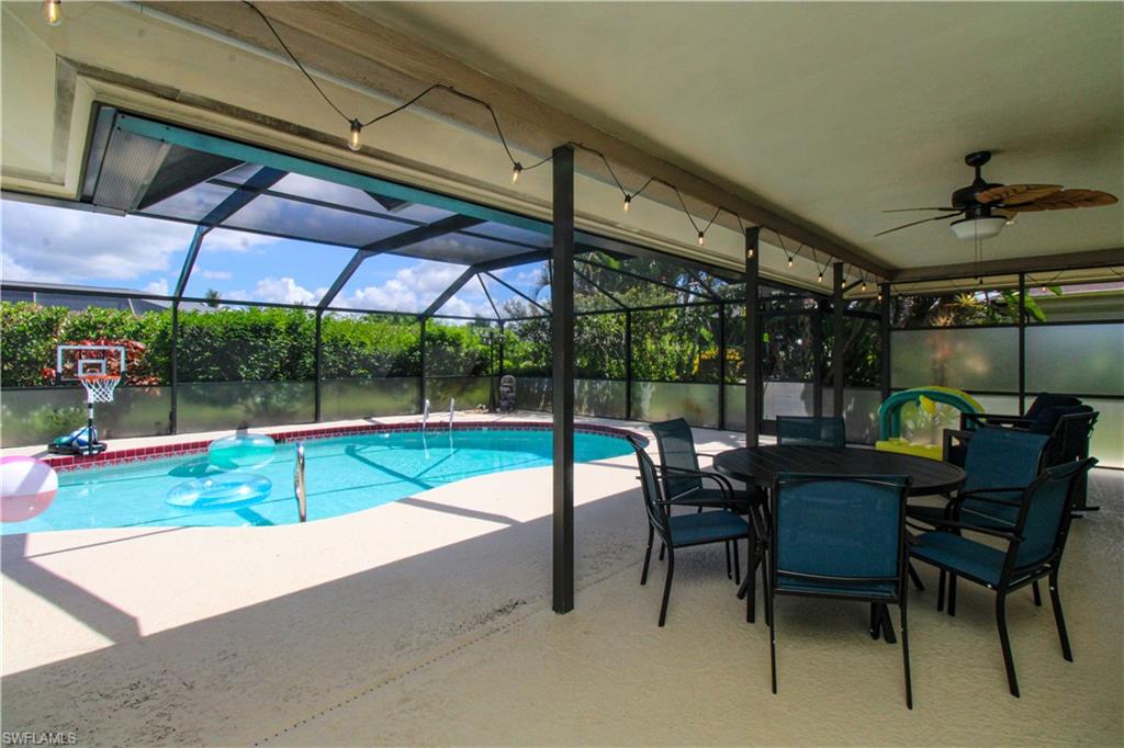 213 Bay Meadows Drive Naples, FL 34113 - Photo 46 of 50 a view of a chairs and table in patio with a barbeque grill