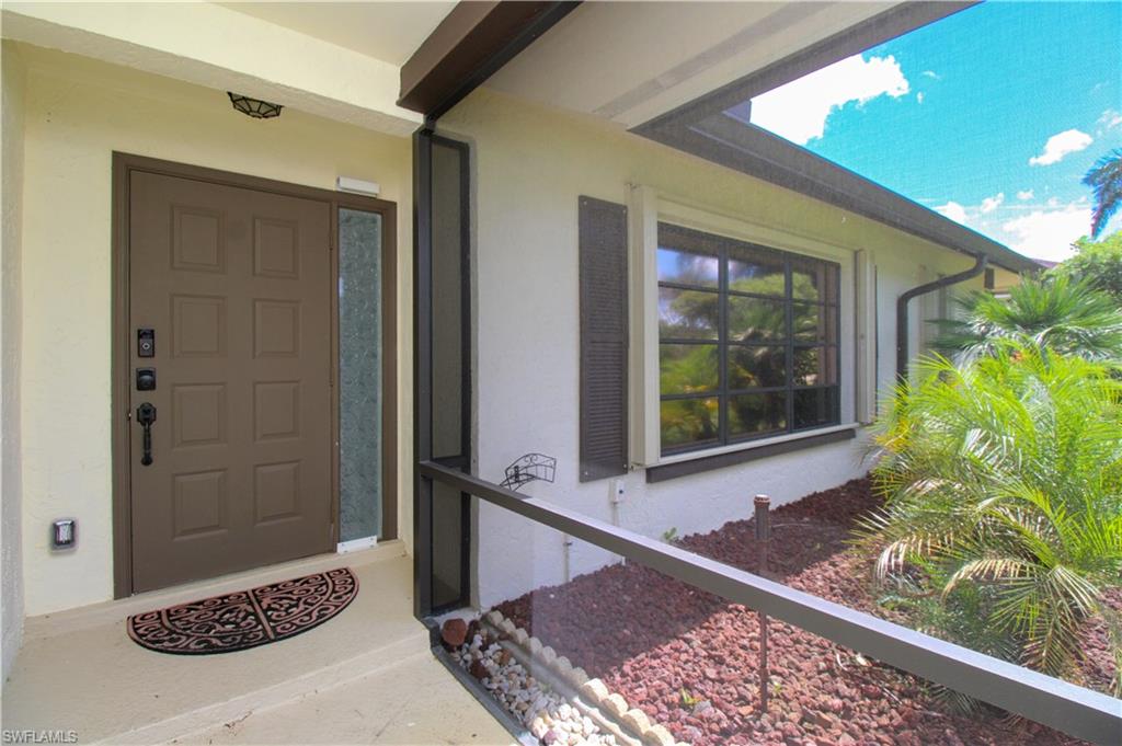 213 Bay Meadows Drive Naples, FL 34113 - Photo 8 of 50 a view of a door and wooden floor