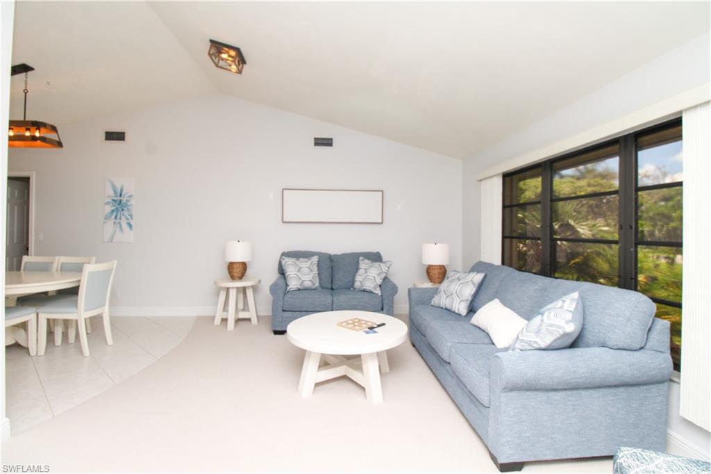 213 Bay Meadows Drive Naples, FL 34113 - Photo 10 of 50 a living room with furniture and a large window