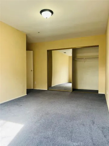 an empty room with closet area