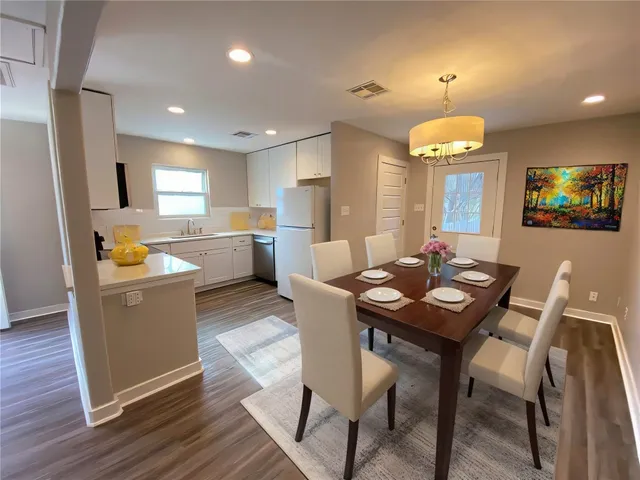a large kitchen with a table and chairs