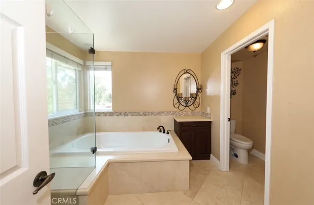 a bathroom with a tub a toilet and a sink