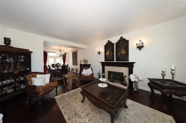 a living room with furniture fireplace and dining table