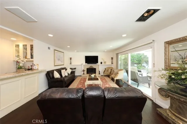 a living room with a couch a large window and a flat screen tv