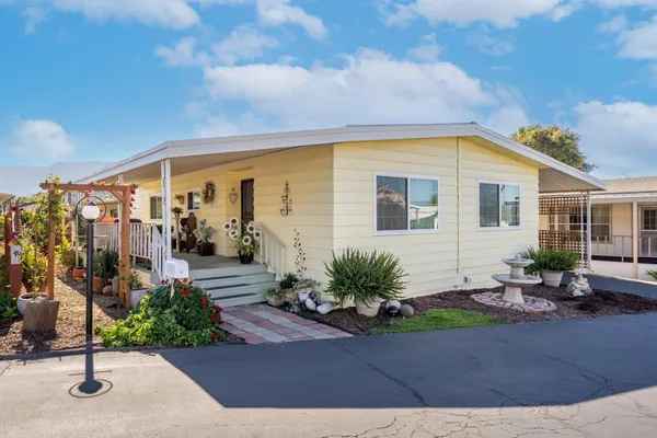 a view of a house with a yard and sitting space