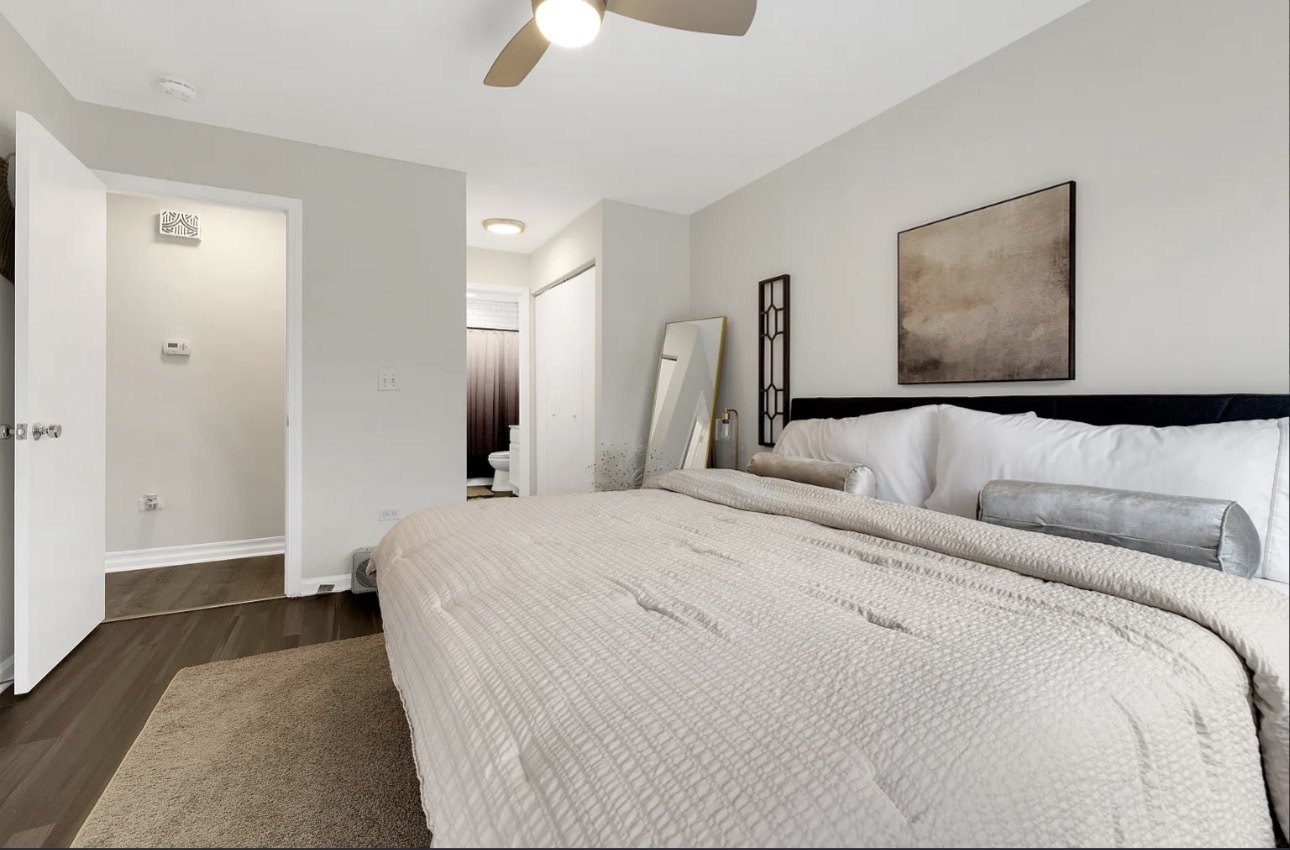 379 Sandhurst Circle, Unit 1 Glen Ellyn, IL 60137 - Photo 14 of 20 a bedroom with a bed and painting on the wall