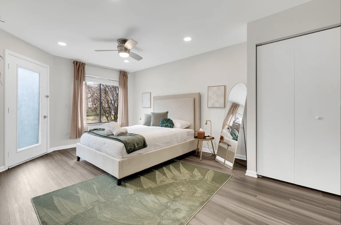 379 Sandhurst Circle, Unit 1 Glen Ellyn, IL 60137 - Photo 5 of 20 a spacious bedroom with a bed and a couch