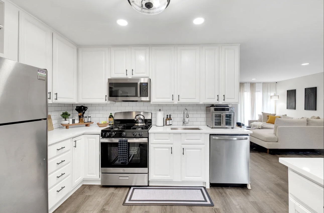 379 Sandhurst Circle, Unit 1 Glen Ellyn, IL 60137 - Photo 8 of 20 a kitchen with white cabinets and white appliances