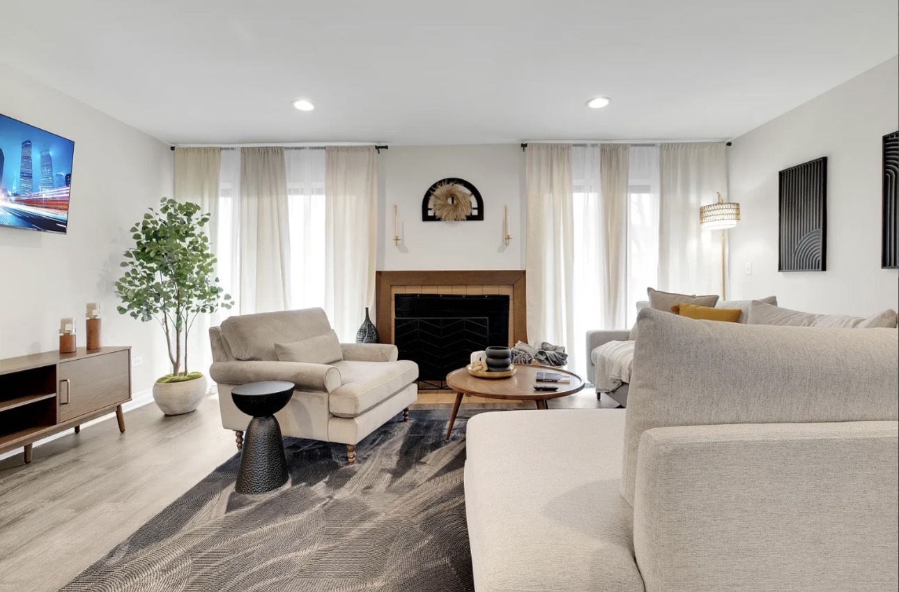 379 Sandhurst Circle, Unit 1 Glen Ellyn, IL 60137 - Photo 10 of 20 a living room with furniture and a fireplace