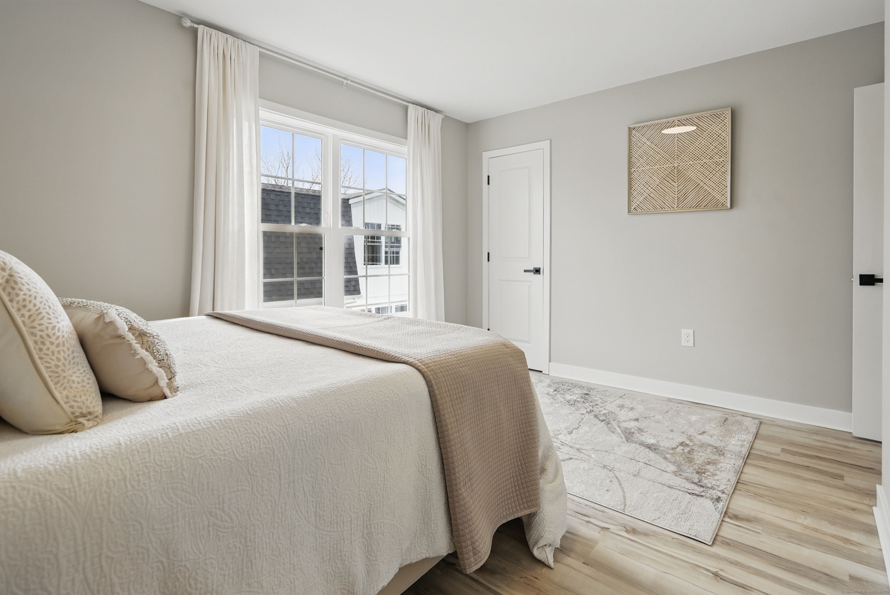 409 Prospect Avenue, Unit 5 West Hartford, CT 06119 - Photo 11 of 25 a bedroom with a bed and a window