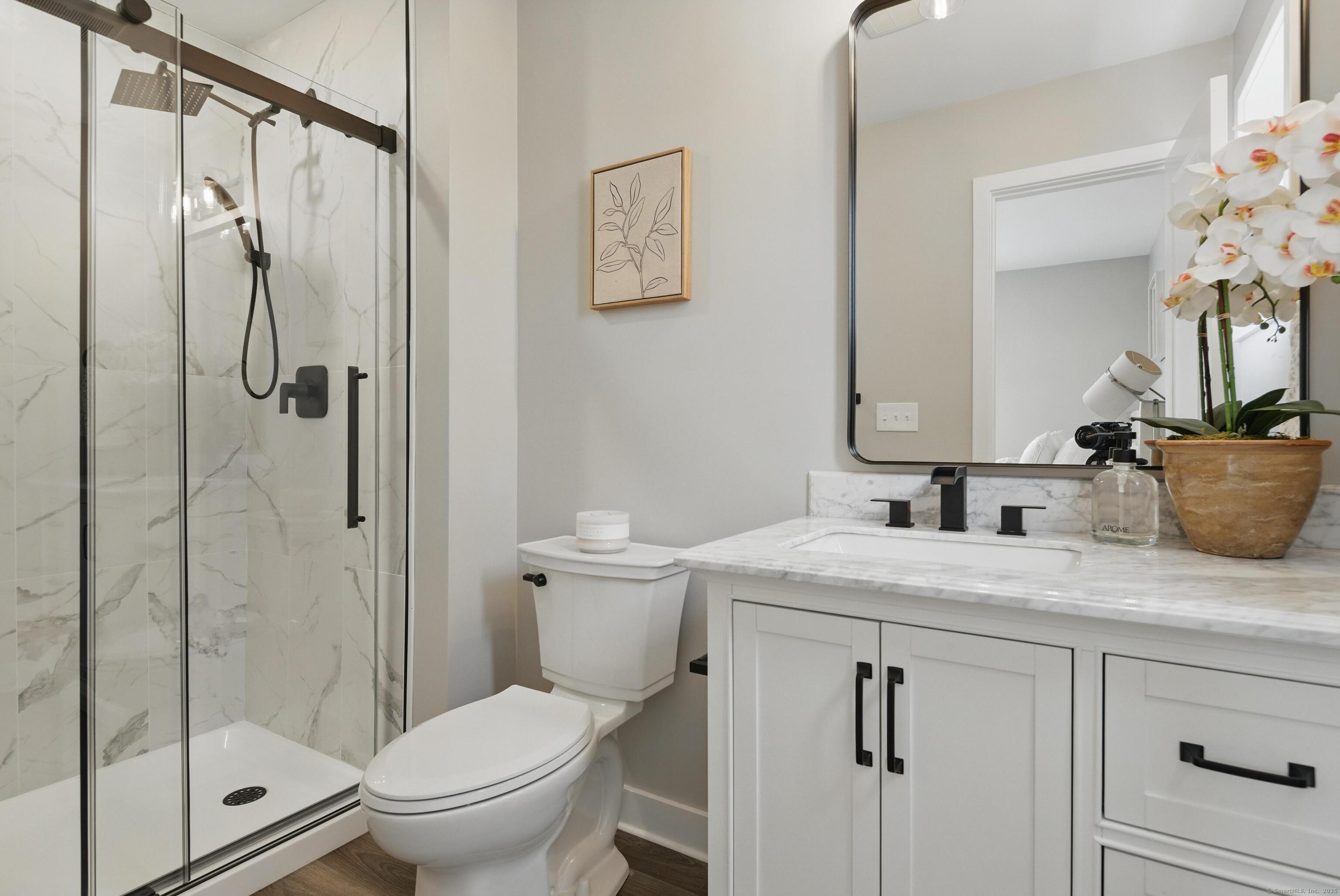 409 Prospect Avenue, Unit 5 West Hartford, CT 06119 - Photo 12 of 25 a bathroom with a granite countertop sink toilet and shower