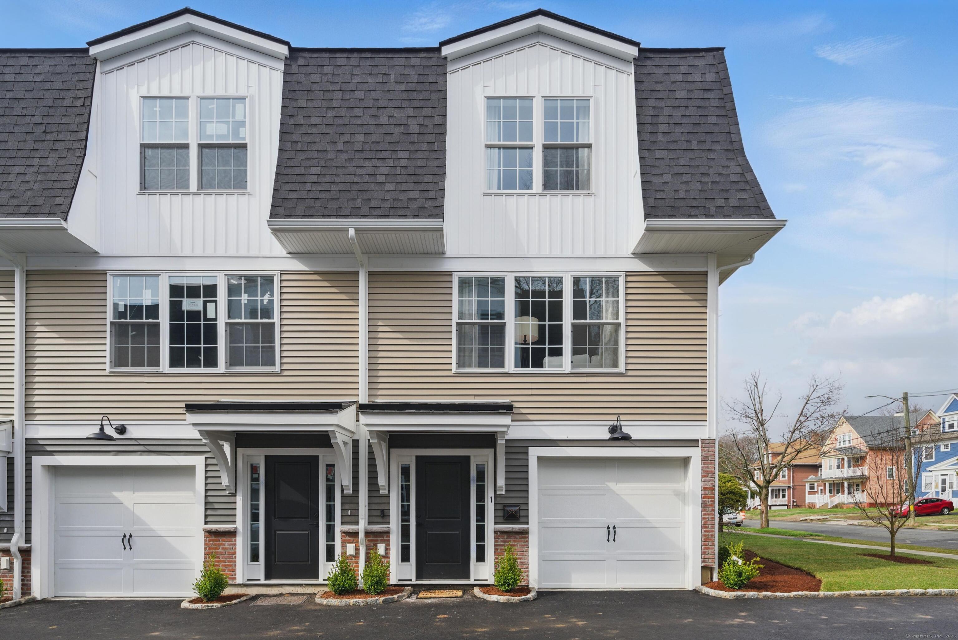 409 Prospect Avenue, Unit 5 West Hartford, CT 06119 - Photo 2 of 25 a front view of a residential apartment building with a yard