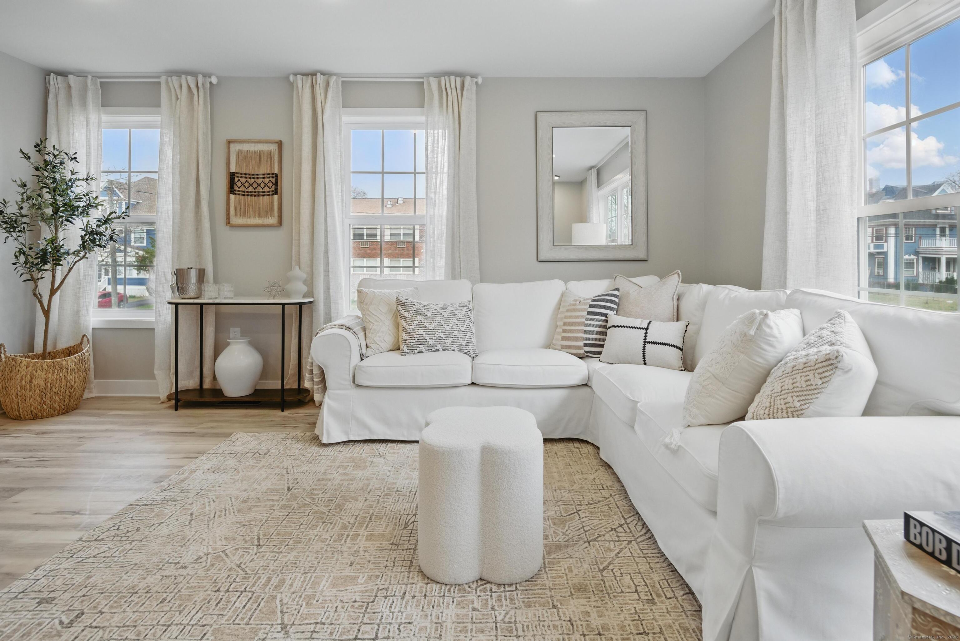 409 Prospect Avenue, Unit 5 West Hartford, CT 06119 - Photo 4 of 25 a living room with furniture and a potted plant