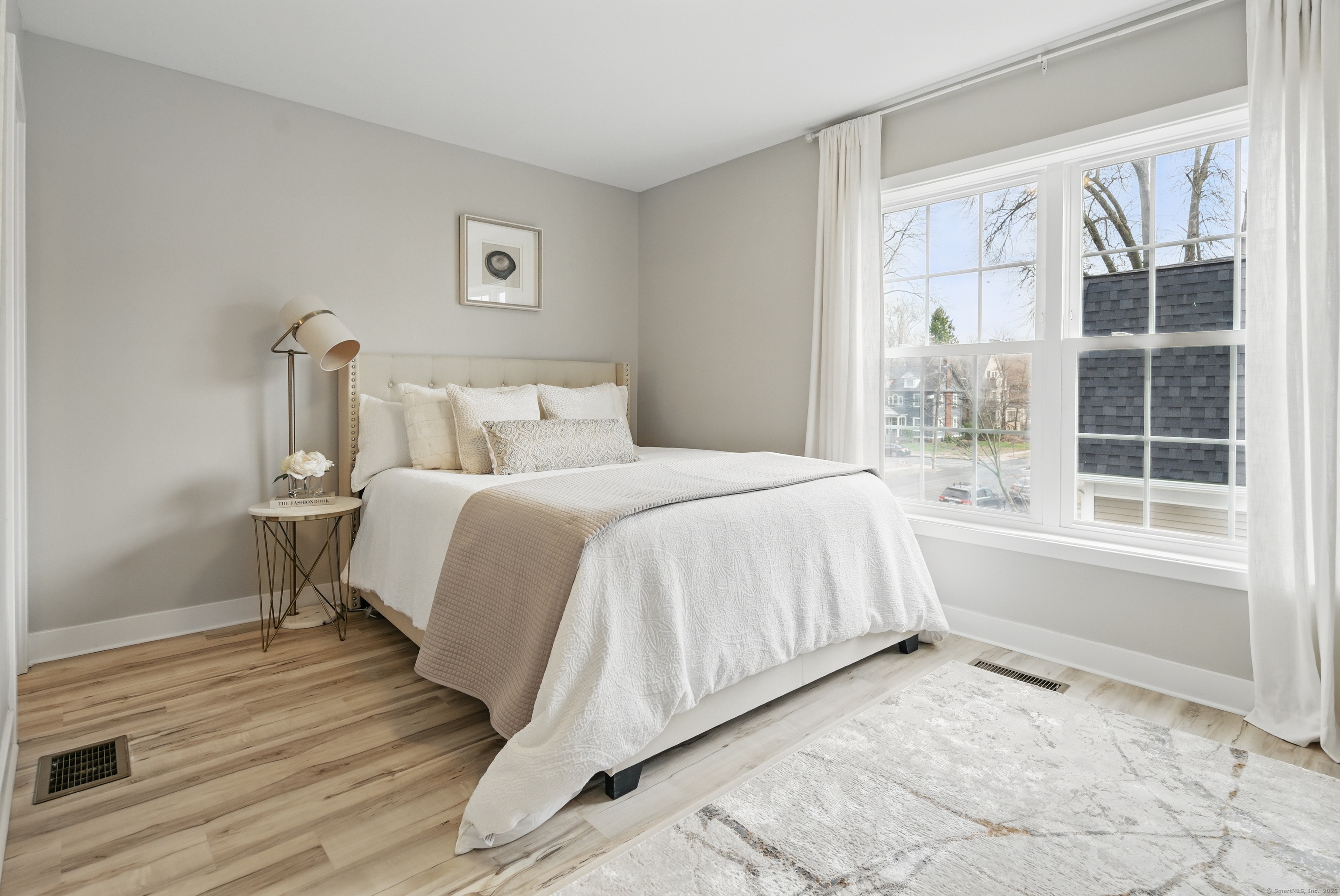 409 Prospect Avenue, Unit 5 West Hartford, CT 06119 - Photo 10 of 25 a bedroom with a bed and a large window