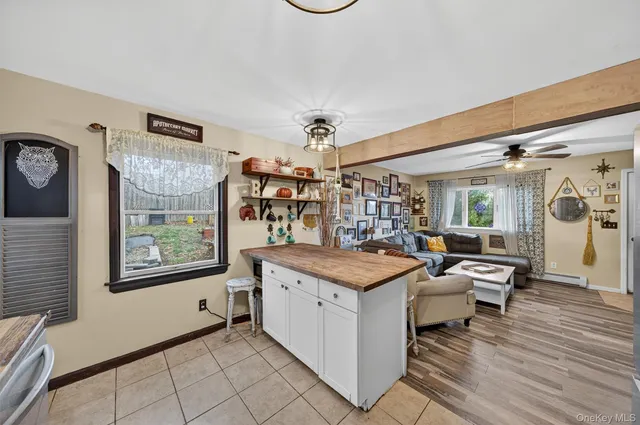a view of a house with wooden deck and a backyard
