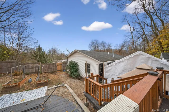 a backyard of a house with barbeque oven table and chairs