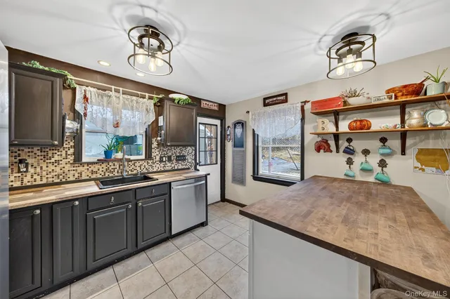 a kitchen with stainless steel appliances granite countertop a sink and cabinets