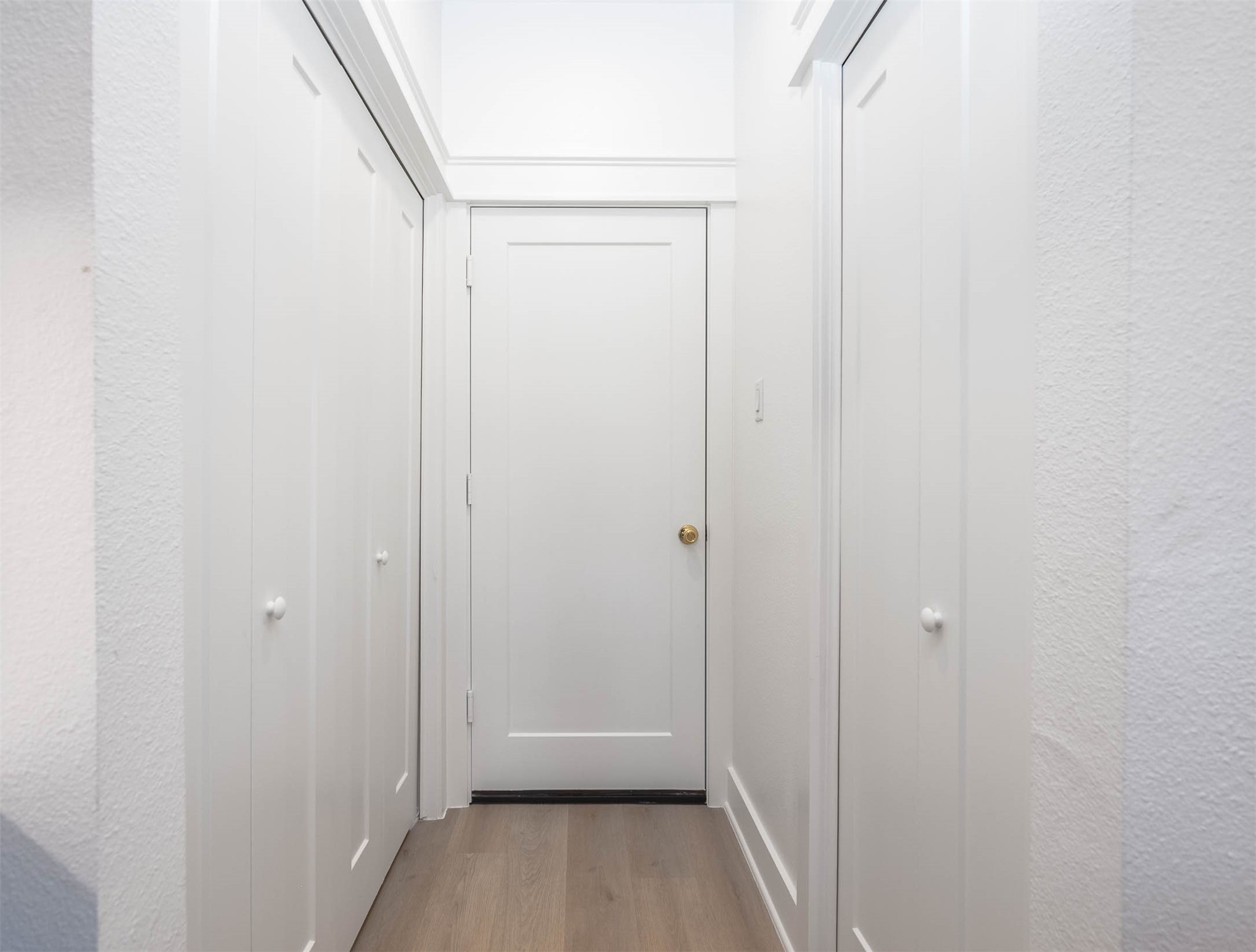 8602 Hoffman Street Houston, TX 77016 - Photo 11 of 30 Hallway leading to the garage with pantry on the left and utility room on the right.