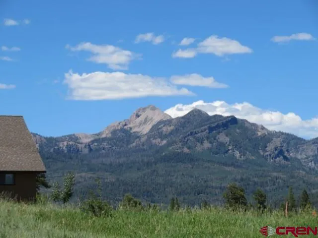 a view of a house with a mountain ground