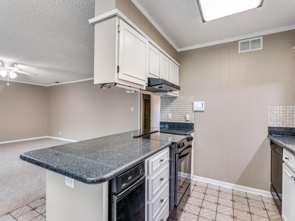 1216 Manning Street Benbrook, TX 76126 - Photo 26 of 26 Kitchen featuring decorative backsplash, white cabinets, ornamental molding, black appliances, and open floor plan