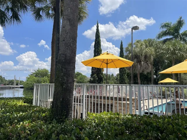 a view of a backyard with a garden and fire pit