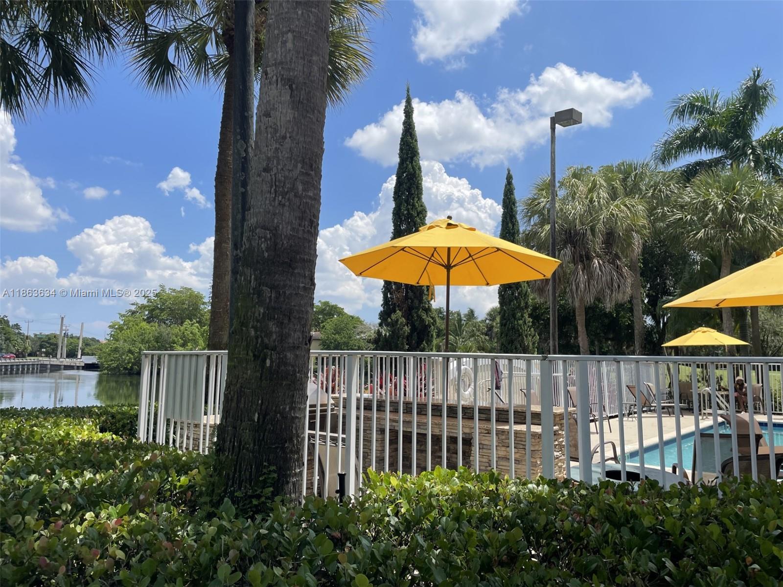 145 Southwest 96th Terrace, Unit 145 Plantation, FL 33324 - Photo 14 of 39 a view of a backyard with a garden and fire pit
