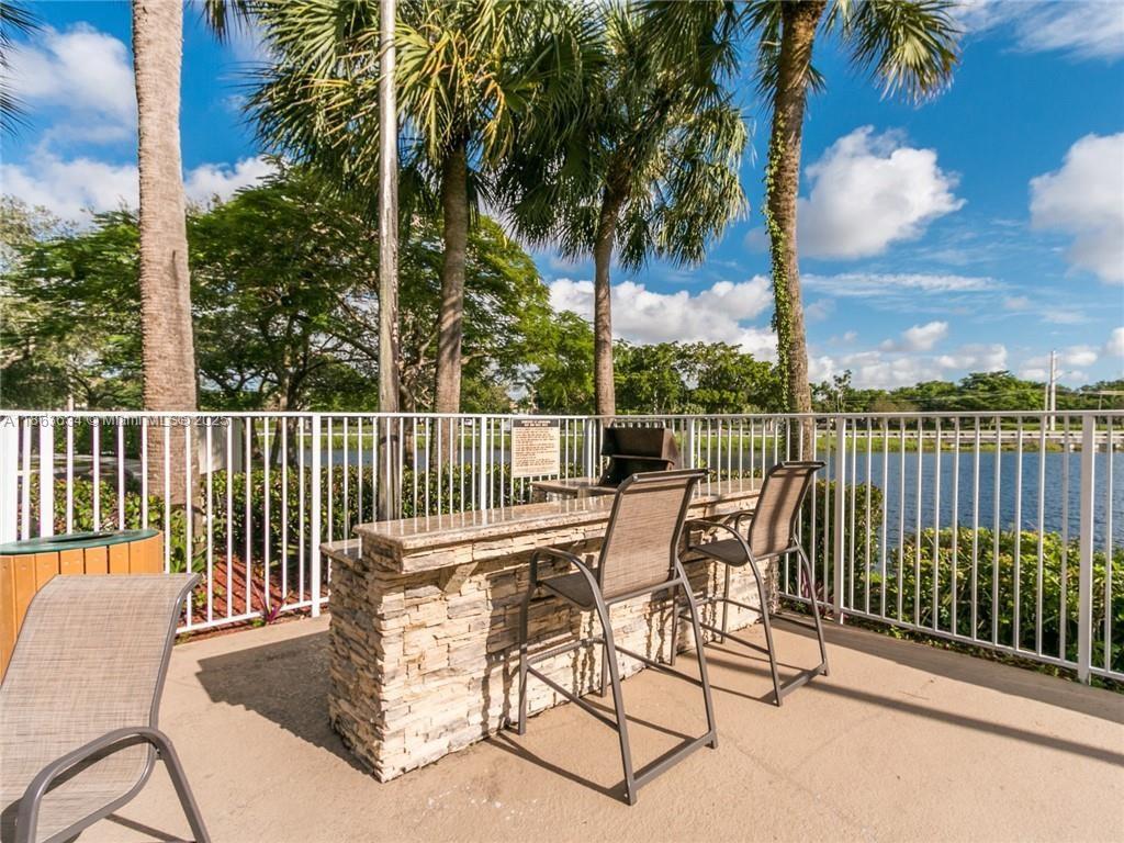 145 Southwest 96th Terrace, Unit 145 Plantation, FL 33324 - Photo 2 of 39 a view of a chair and tables