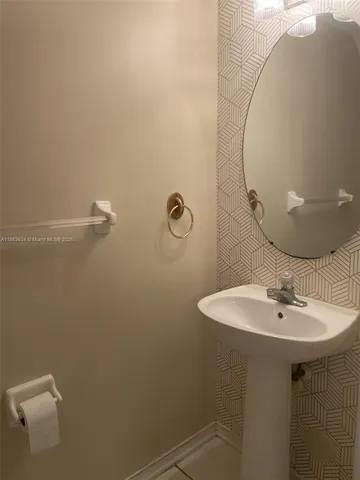 a bathroom with a sink a mirror and a shower
