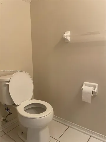 a white toilet sitting next to a shower