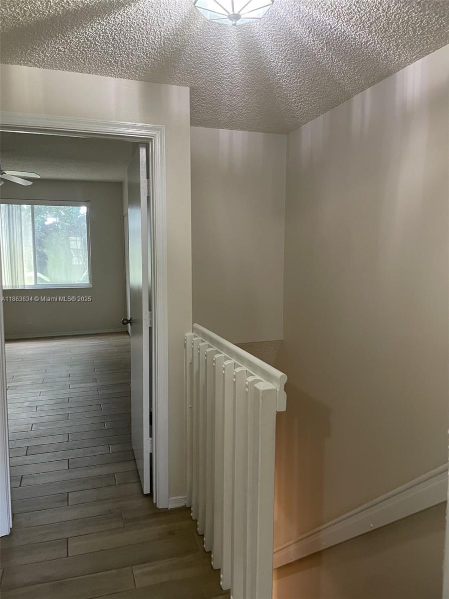 145 Southwest 96th Terrace, Unit 145 Plantation, FL 33324 - Photo 27 of 39 a view of a hallway with wooden floor