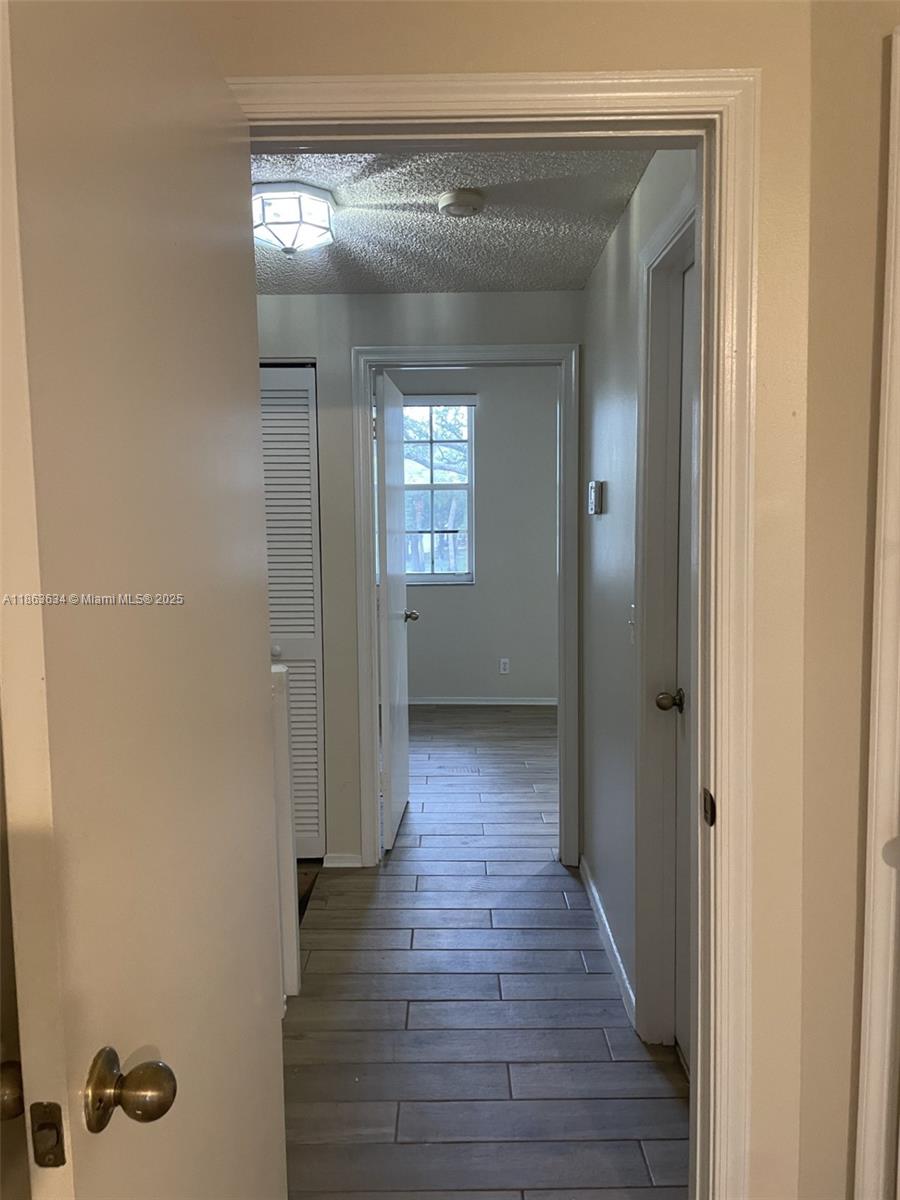 145 Southwest 96th Terrace, Unit 145 Plantation, FL 33324 - Photo 31 of 39 a view of a hallway with wooden floor