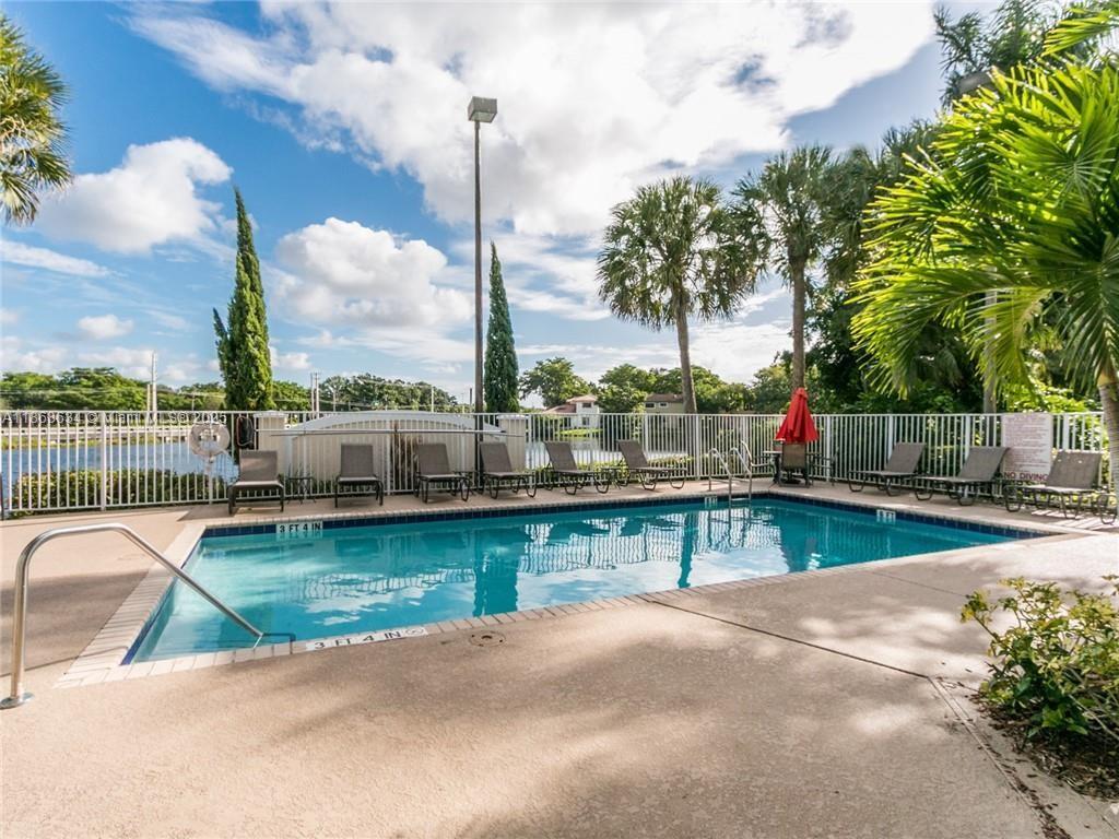 145 Southwest 96th Terrace, Unit 145 Plantation, FL 33324 - Photo 4 of 39 a view of a swimming pool with a lounge chairs