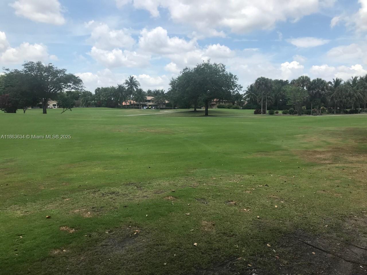 145 Southwest 96th Terrace, Unit 145 Plantation, FL 33324 - Photo 5 of 39 a view of grassy field with trees