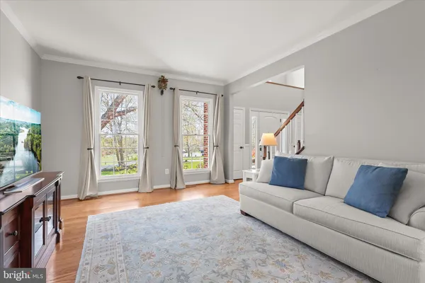 a kitchen with stainless steel appliances a dining table chairs and wooden floor