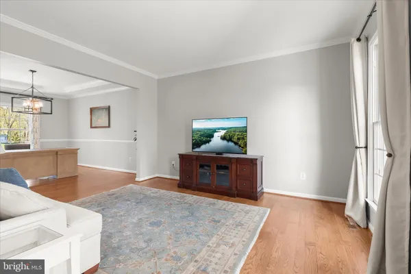 a kitchen with stainless steel appliances granite countertop wooden cabinets a sink and dishwasher with wooden floor