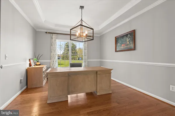 a kitchen with stainless steel appliances a dining table chairs stove microwave and cabinets