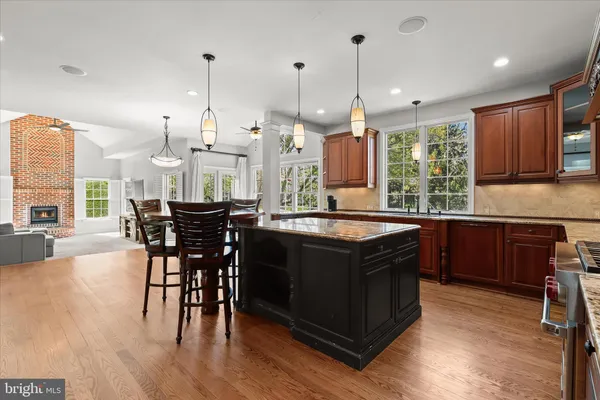 a kitchen with stainless steel appliances granite countertop a stove and cabinets