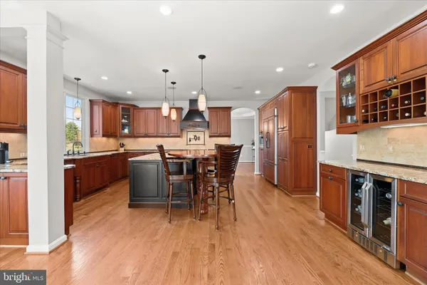 a spacious bedroom with a bed and a dresser