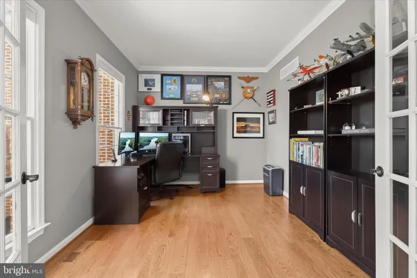 a view of bedroom and hall with wooden floor